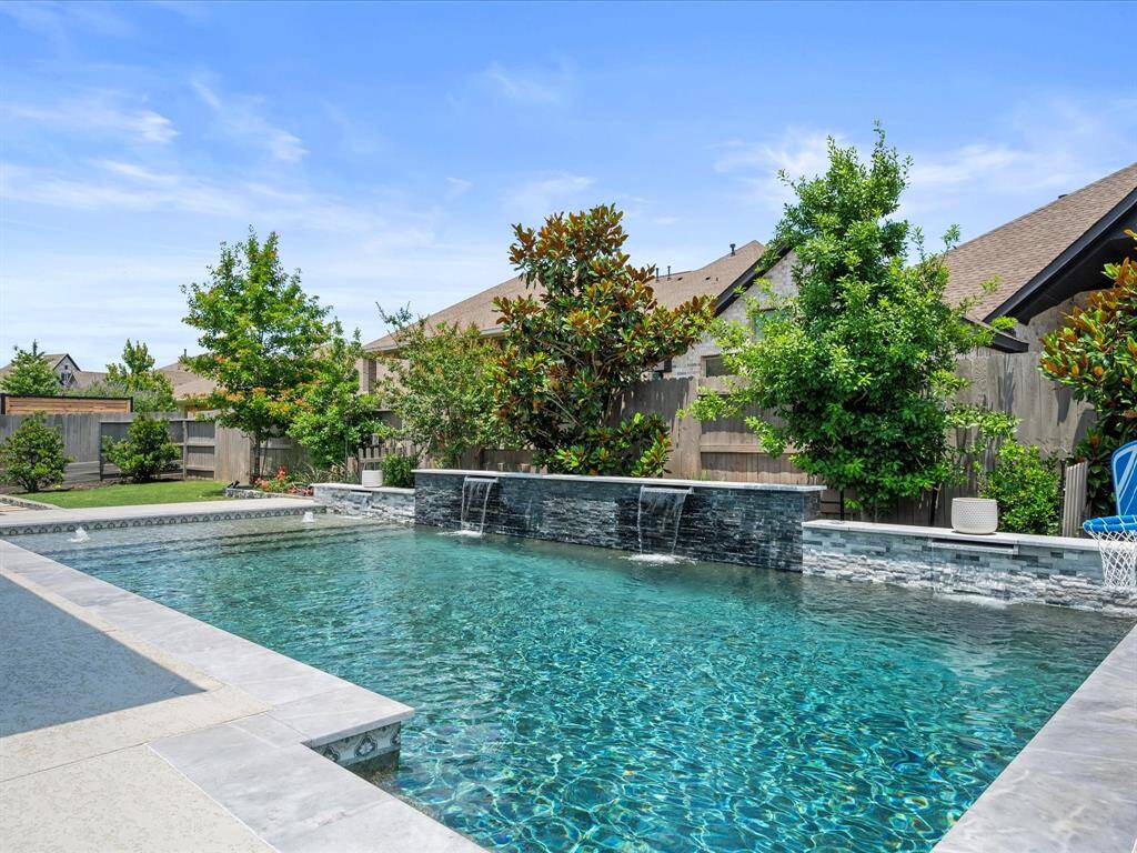 Custom Built HEATED Pool featuring upgraded dark gunite, water features AND Baja Shelf.  Pool mechanics are PENTAIR PRODUCTS!