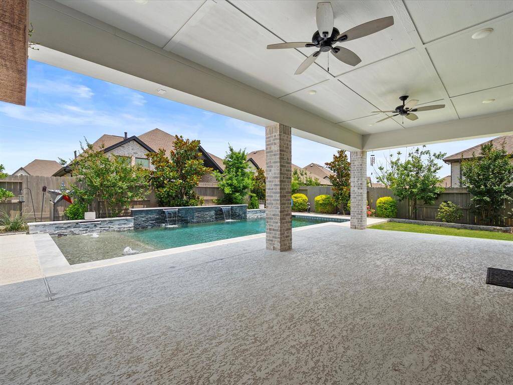 MASSIVE Covered Rear Patio providing the perfect setting to entertain with loved ones!  Surround Sound Pre-Wiring, outdoor fans, TV & Fireplace!