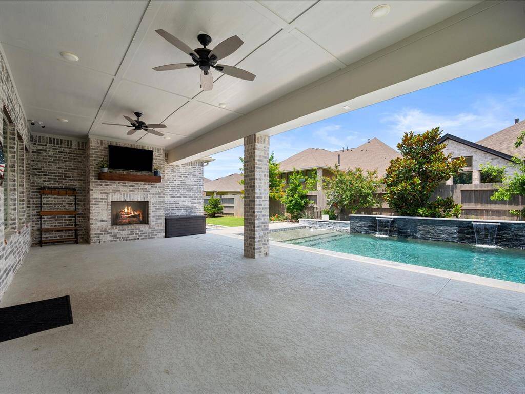 MASSIVE Covered Rear Patio providing the perfect setting to entertain with loved ones!  Surround Sound Pre-Wiring, outdoor fans, TV & Fireplace!