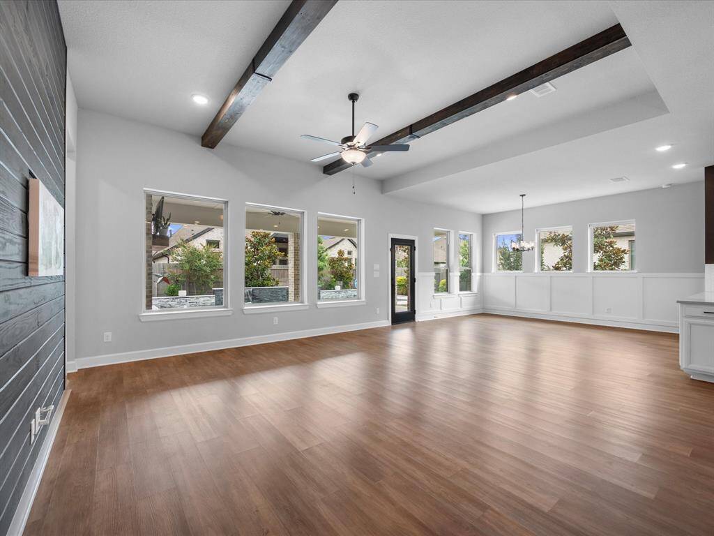 This open concept layout provides much entertaining space for all!  The beams add a nice cozy touch.