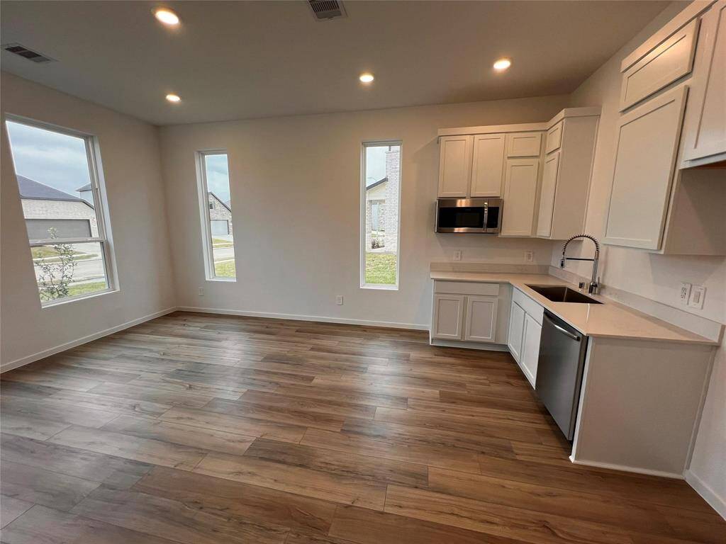 This next-gen suite offers a private and complete living space, featuring its own modern kitchen. Enjoy the convenience and independence of this separate dwelling, ideal for extended family or guests.