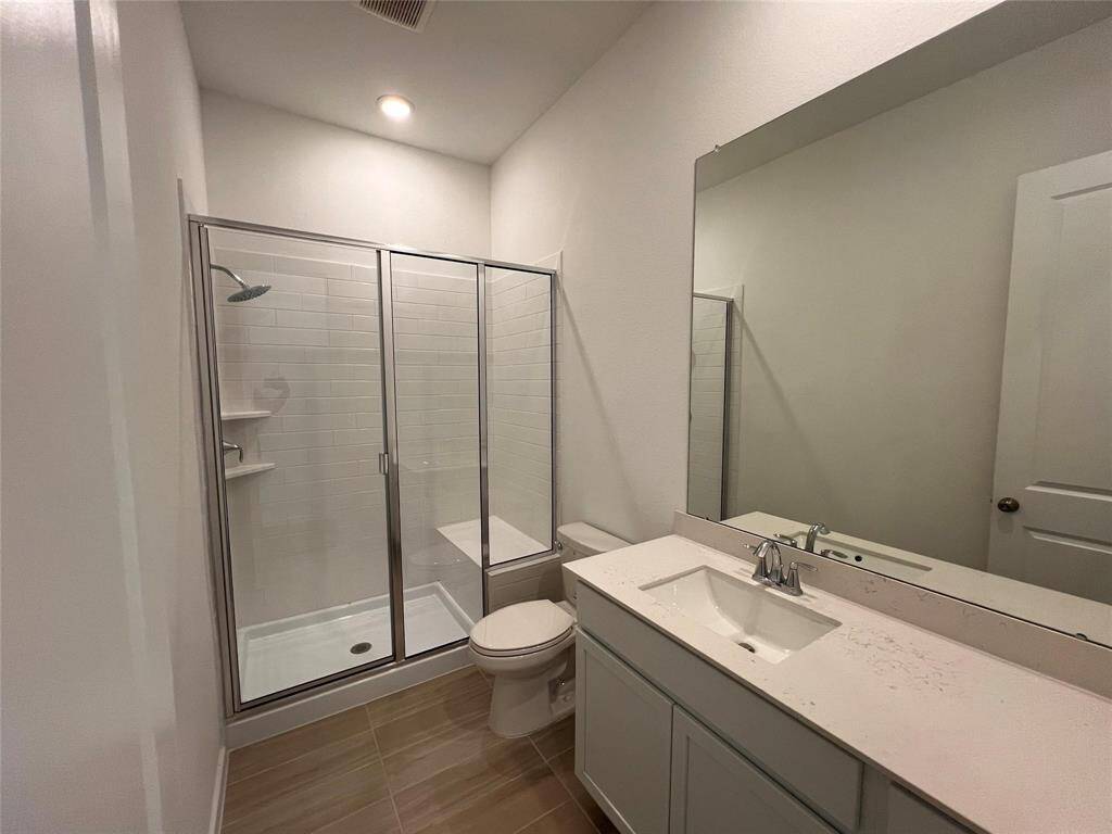 This Next-Gen bathroom offers a clean and contemporary design with a convenient walk-in shower. It features a sleek vanity and modern fixtures, providing a comfortable and private space.