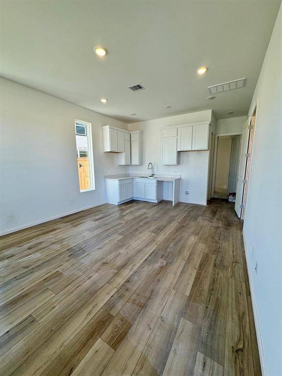 This inviting Next Gen living area seamlessly integrates with a convenient kitchenette, offering a versatile and self-contained space. Bright and airy, it features modern flooring and ample natural light, perfect for independent living.