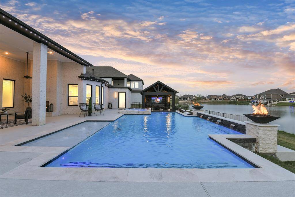 Welcome home to 18115 Bachman Branch Dr in gated Marina Bay section of Towne Lake - this showstopper home has all features for perfect lake living.