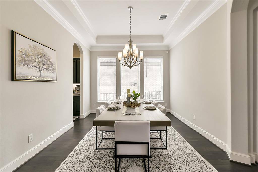 Elegant dining space with double crown molding and graceful arched doorways—where timeless design meets everyday comfort.