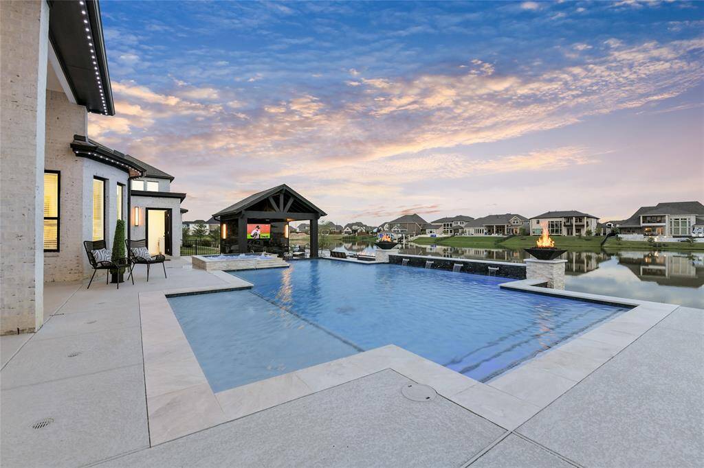 Multiple poolside seating areas invite relaxation, warmed by dual fire features and framed by stunning views.