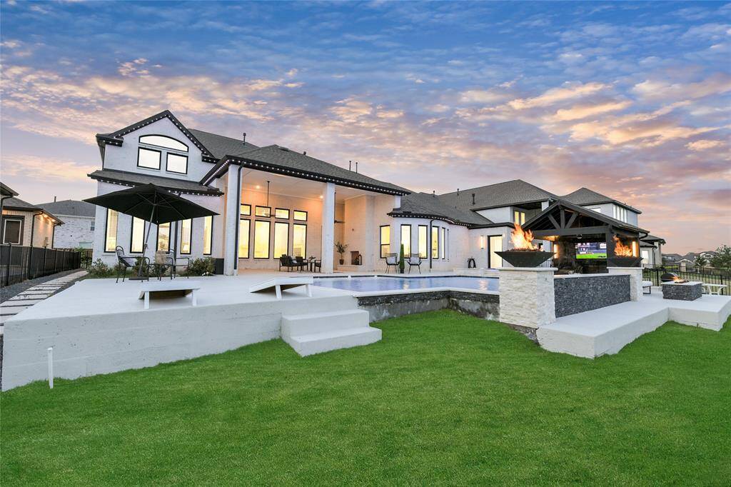 Cozy firepit area surrounded by lush landscaping and a sun-drenched deck—perfect for evenings and sunny afternoons alike.