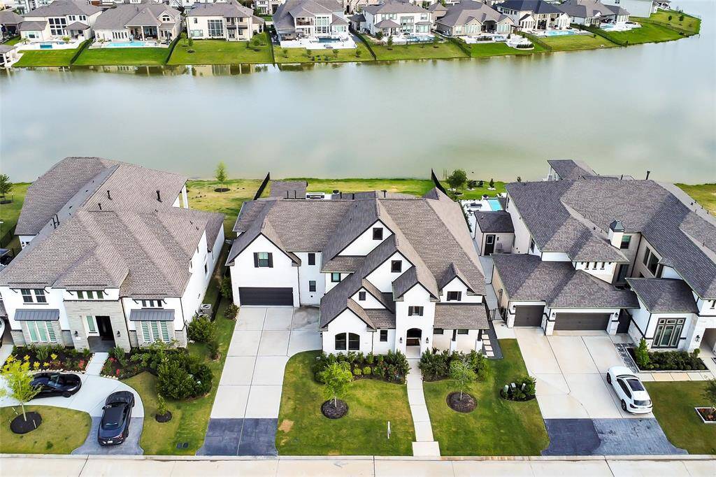 Aerial view captures the home's impressive footprint and stunning lake vistas—where luxury meets nature’s beauty.