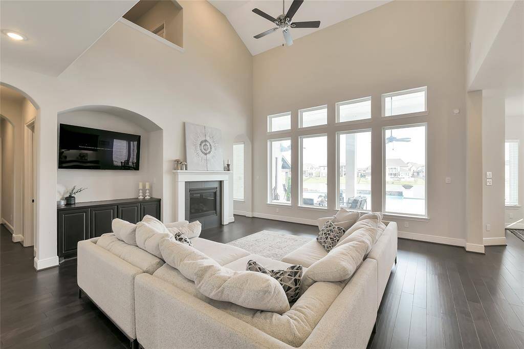 So much natural light flows into the Family Room with gas log fireplace, ceiling fan and wall to wall windows with views to the lake.