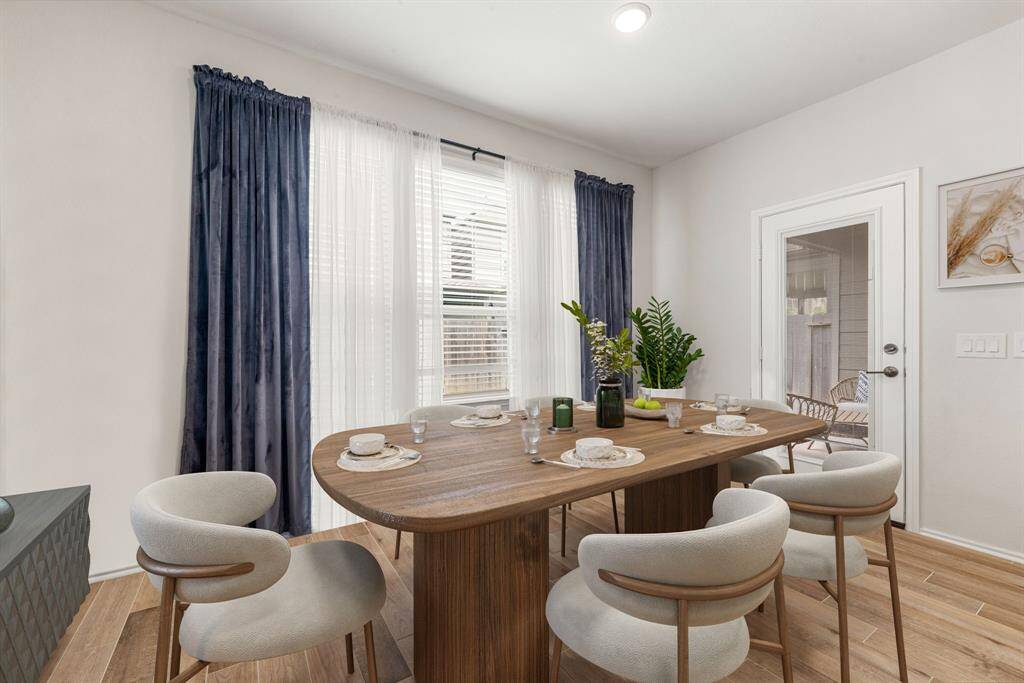 Gather, dine, and celebrate! Framed by elegant molding and warm natural light, this open-concept dining room offers the perfect backdrop for everything from casual weeknight meals to memorable holiday feasts. *Virtually Staged
