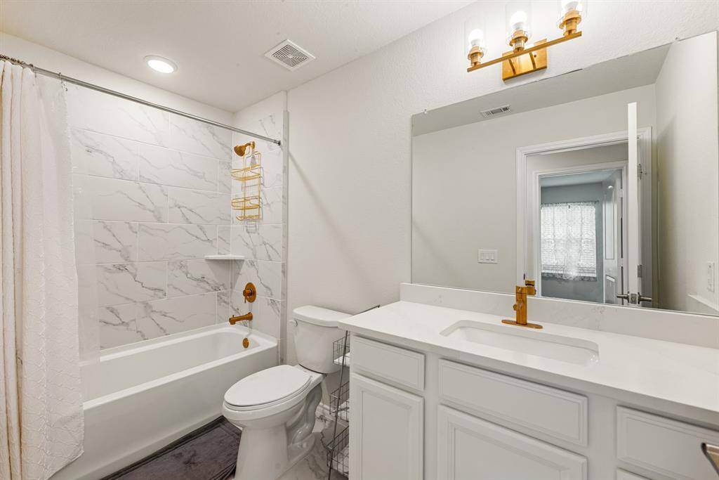 Secondary bedroom features plush carpet, custom paint, dark stained ceiling fan with lighting and a large window with privacy blinds. *Virtually Staged