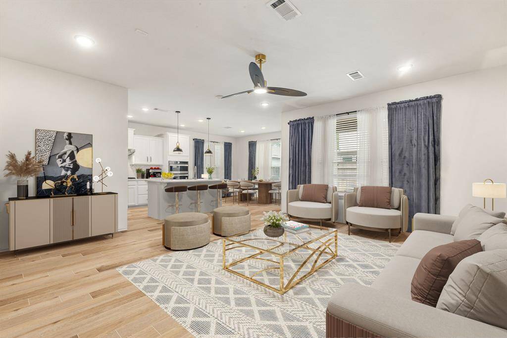 Gather the family and guests together in your lovely living room! Featuring high ceilings, recessed lighting, dark stained ceiling fan, custom paint, gorgeous wood style flooring and large windows that provide plenty of natural lighting throughout the day. *Virtually Staged