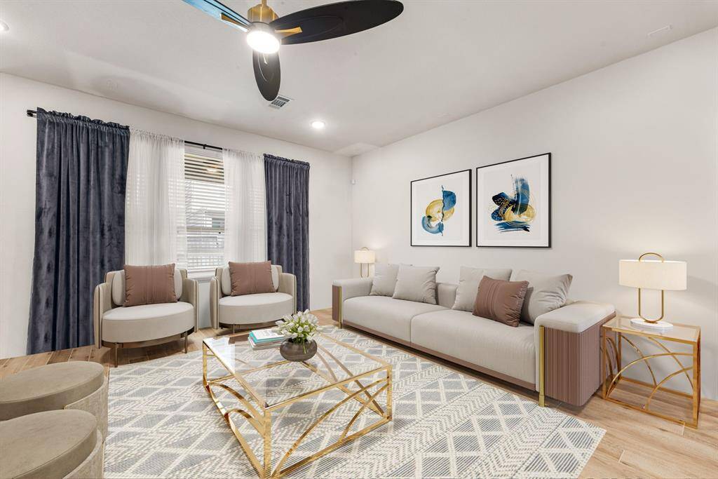 This light and bright spacious living room is the perfect layout for entertaining or just relaxing. Whether it's simply a night in or entertaining family and friends, this home has ample open space for everyone to enjoy! Featuring dark stained ceiling fan, wood style flooring, large windows, recessed lighting with wonderful access to your gorgeous kitchen. *Virtually Staged