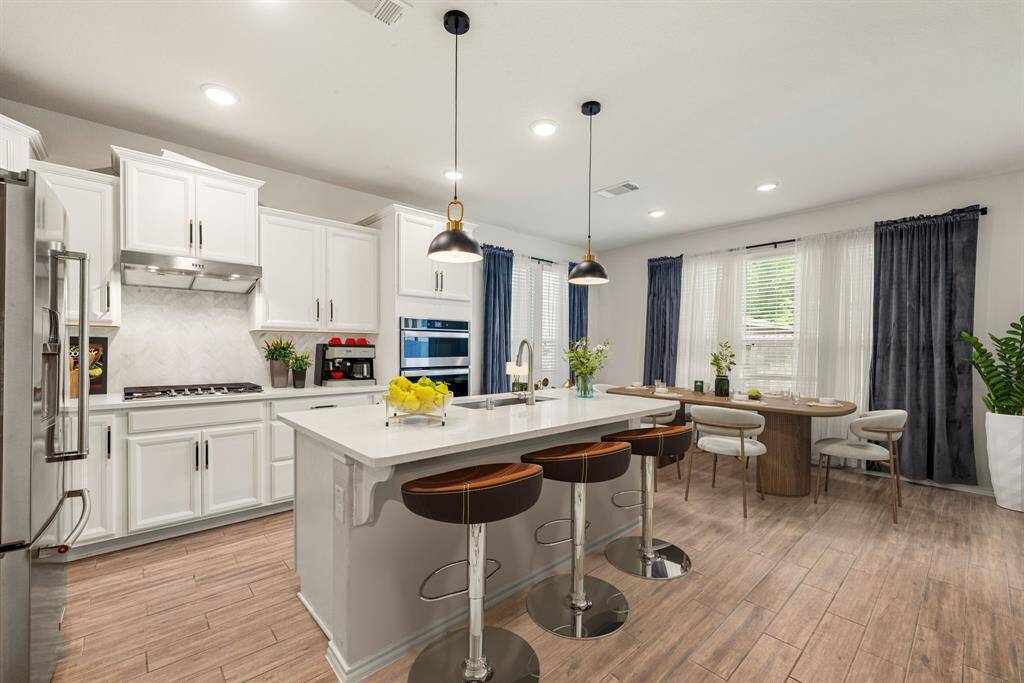 Chef-inspired centerpiece, gleaming cultured marble counters, a spacious island, and premium stainless appliances come together to make cooking a delight. *Virtually Staged