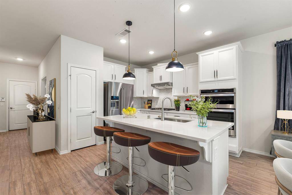 Seamless entertaining hub, the open-concept layout lets conversation flow effortlessly from kitchen to living and dining spaces. *Virtually Staged