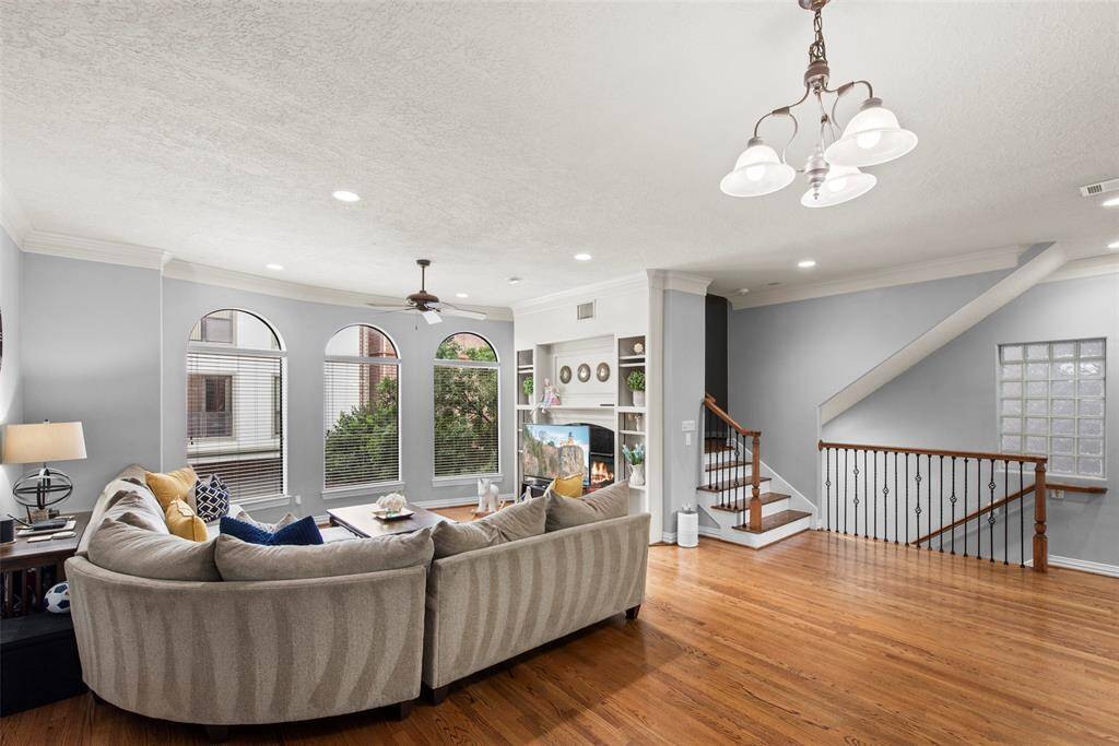 Flooded with natural light and high ceilings this living room is the perfect place to unwind. Get comfortable in front of the gas fireplace for a movie night.