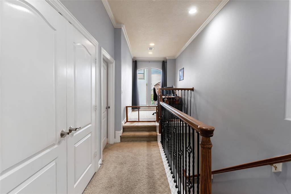 Third floor hallway with utility room behind double doors on left. Extra flex space perfect for another work area on landing overlooking courtyard