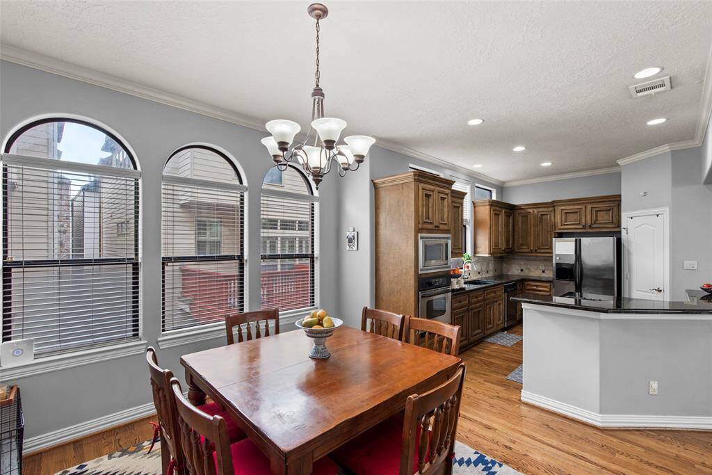 Spacious dining area next to kitchen drenched in sunlight