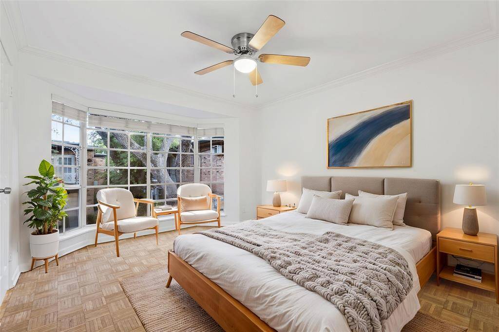 Primary bedroom overlooks picturesque courtyard