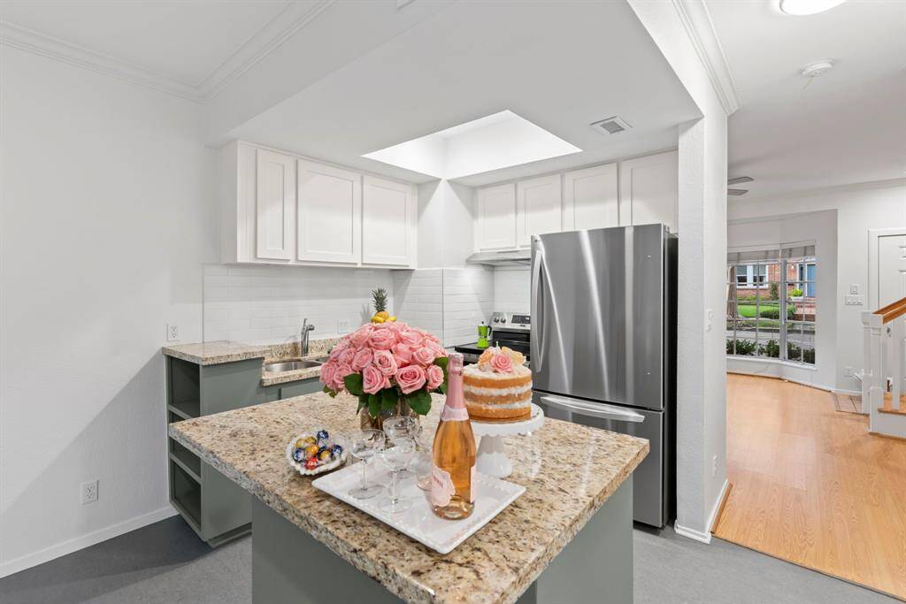 Open concept kitchen just off living room. Moveable granite island perfect for a breakfast bar or entertaining guests