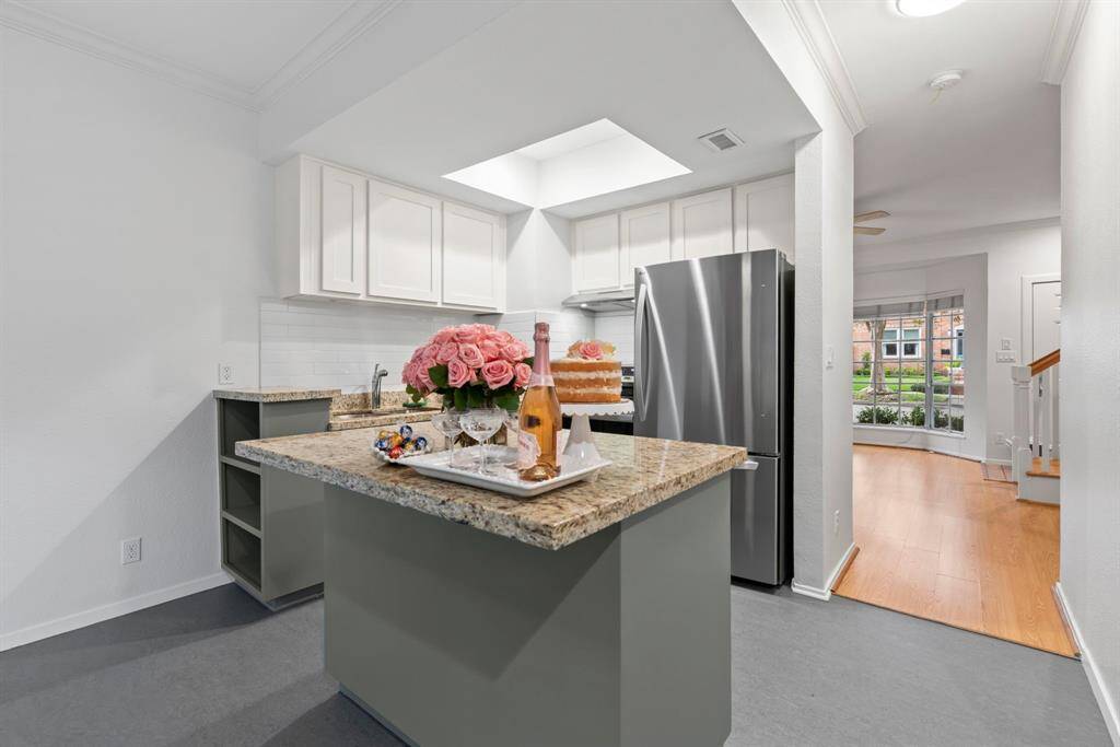 Granite counter tops and center island. NEW stainless steel refrigerator and stove.