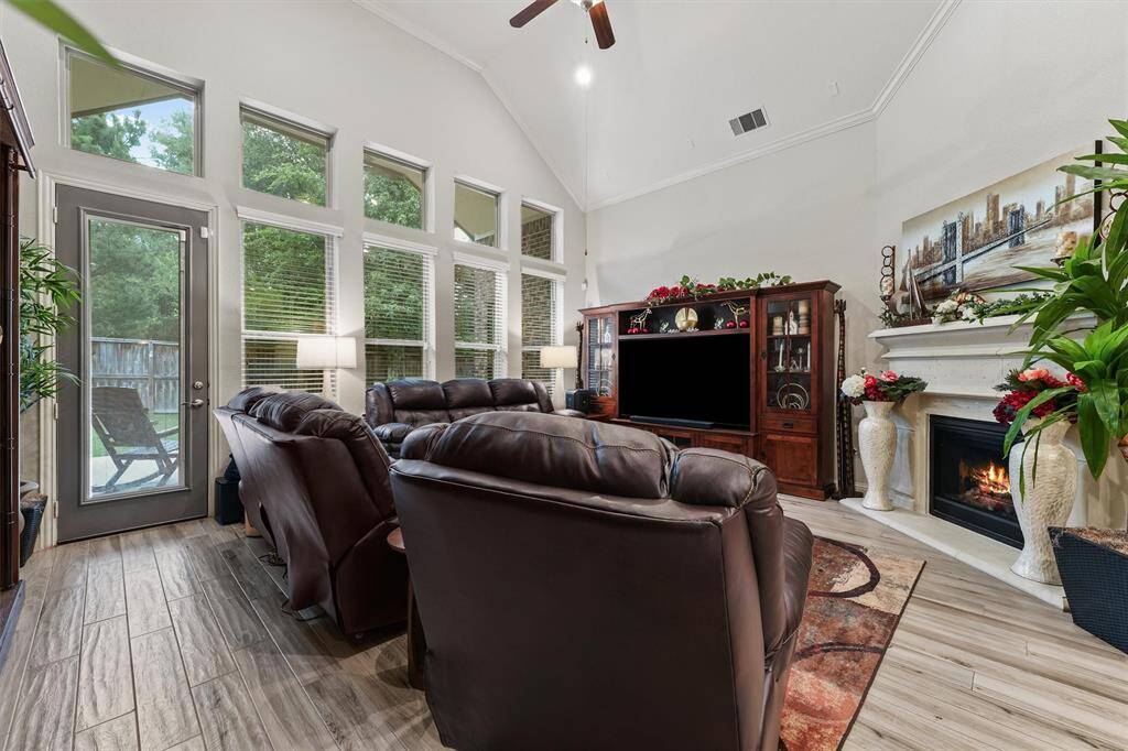 Tall windows and a wall of windows make this single story home feel grand