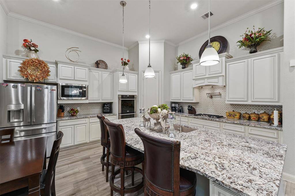 Gorgeous cabinetry, updated backsplash, and a pot filler.