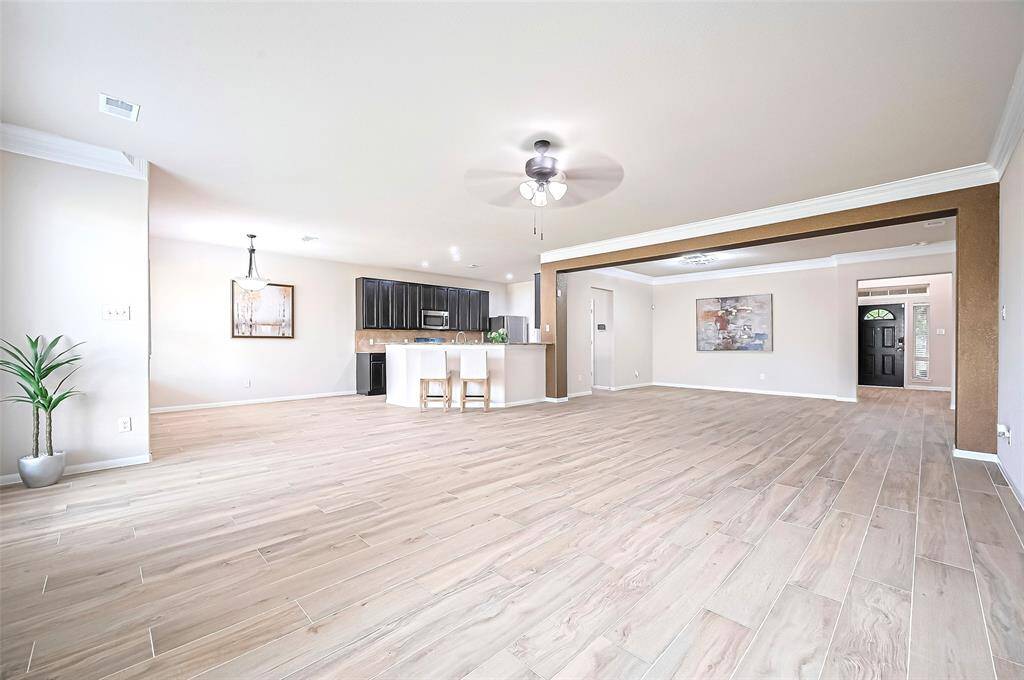 This Stunning Formal Living seamlessly blends with formal Dining, offering inviting atmosphere perfect for entertaining