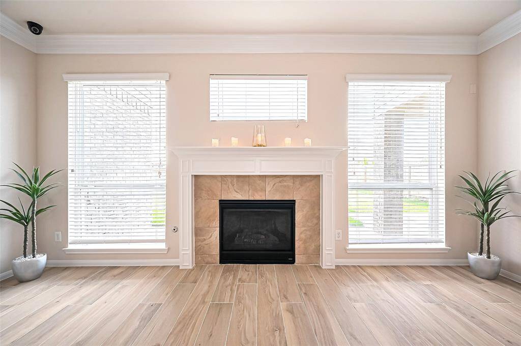 Fireplace serves as a stunning focal point with Tall windows allow abundant natural light