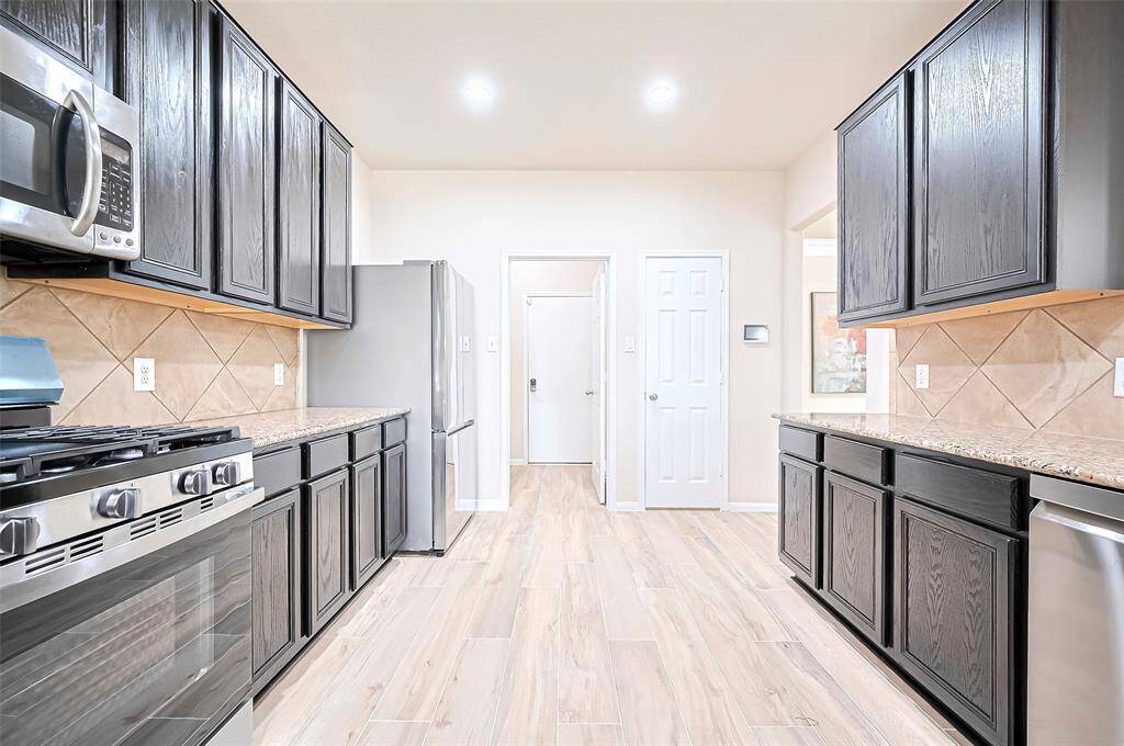 Open kitchen effortlessly connects with the living and dining, creating a harmonious flow ideal for gatherings