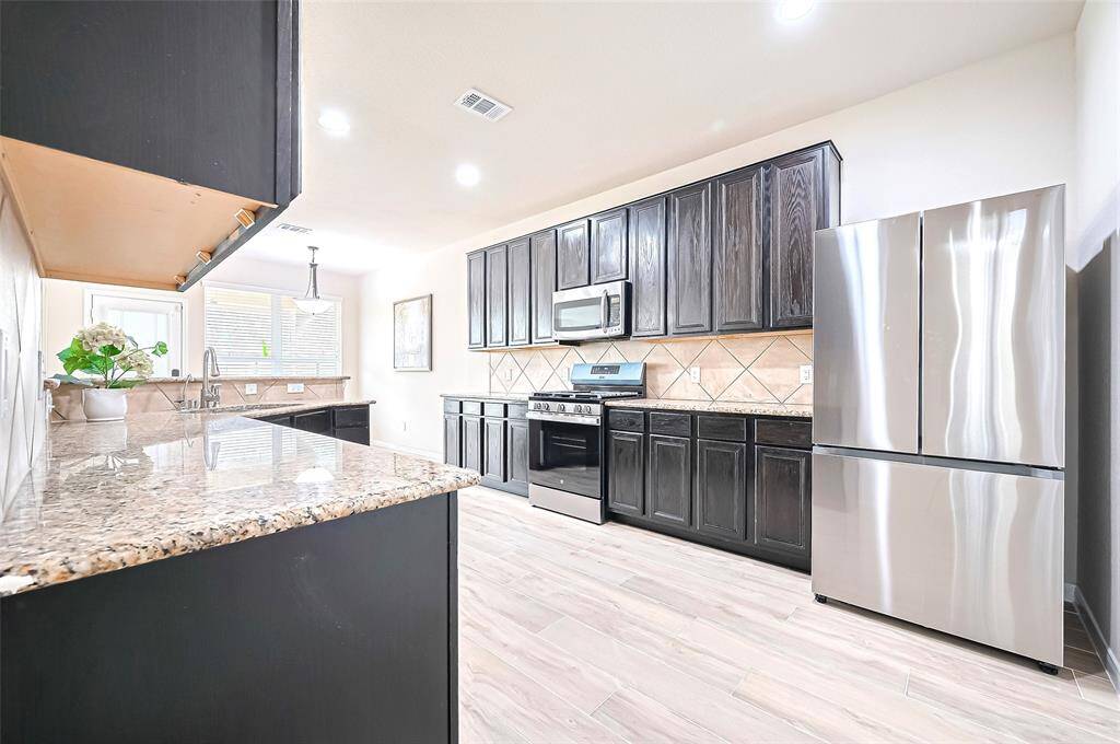 Modern energy-efficient kitchen appliances, such as New SS Refrigerator, New gas range, New Dishwasher, add both functionality and style.