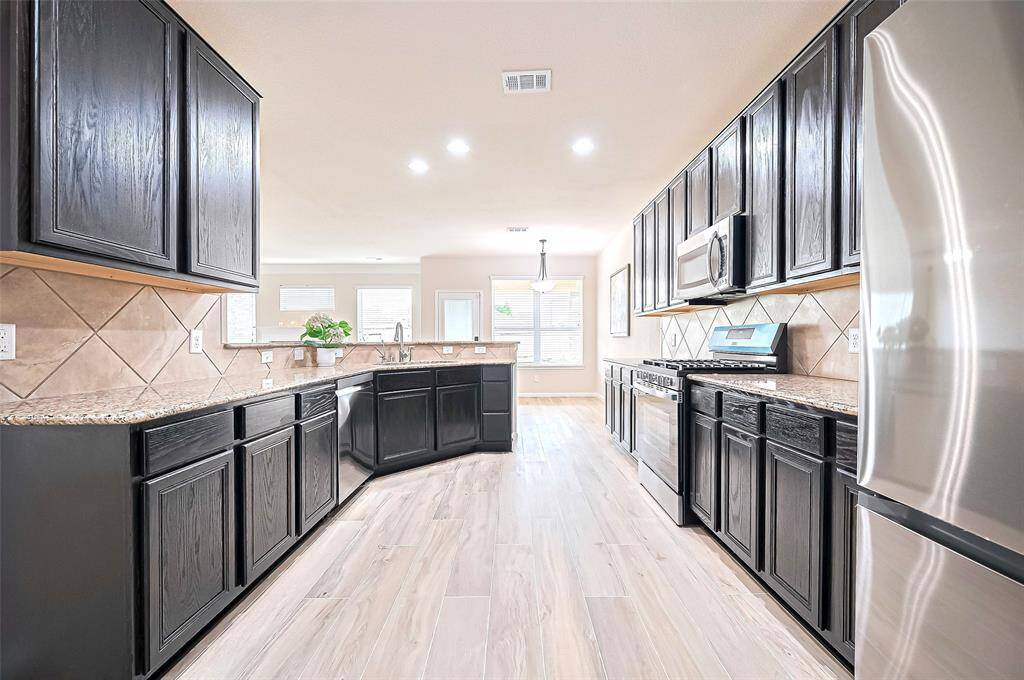 Sleek countertops, modern cabinetry, and a well-equipped cooking space make it a chef’s dream