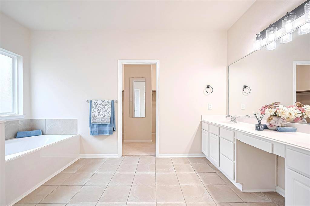 This master bath offers spacious layout of luxury and functionality, creating a personal retreat designed for relaxation and convenience