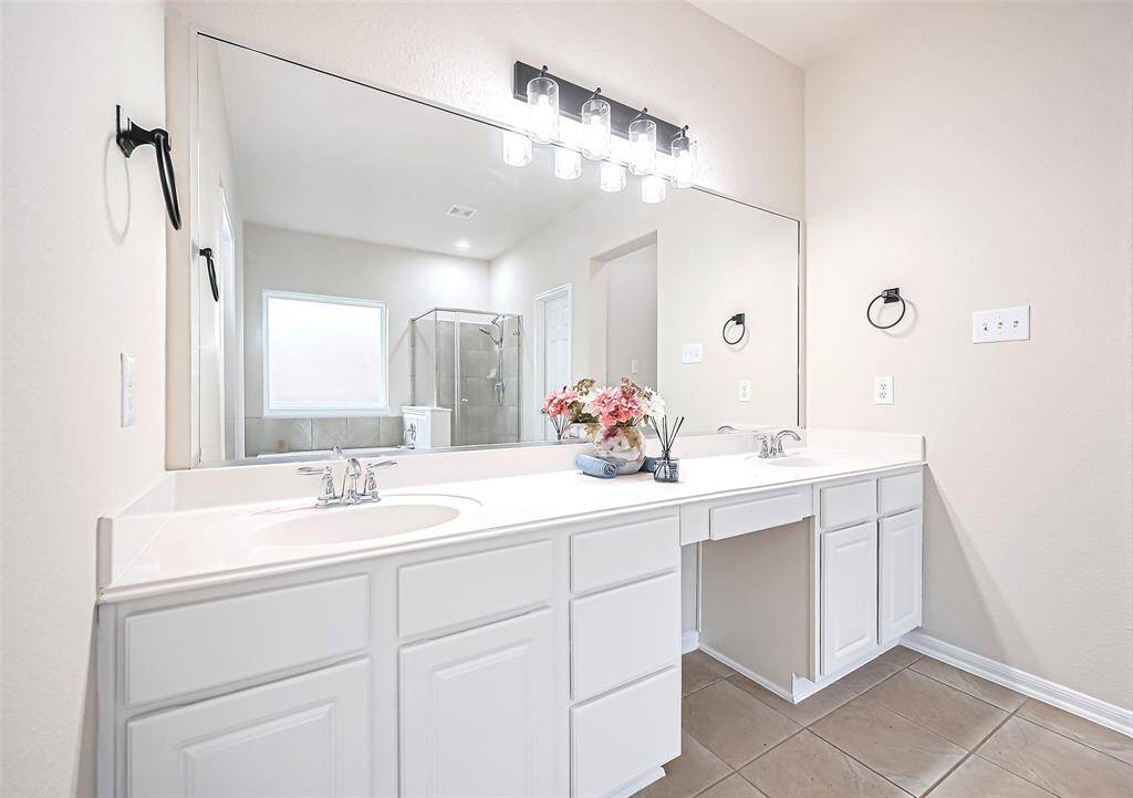 This master bath offers his-and-her sink with plenty of storage space.