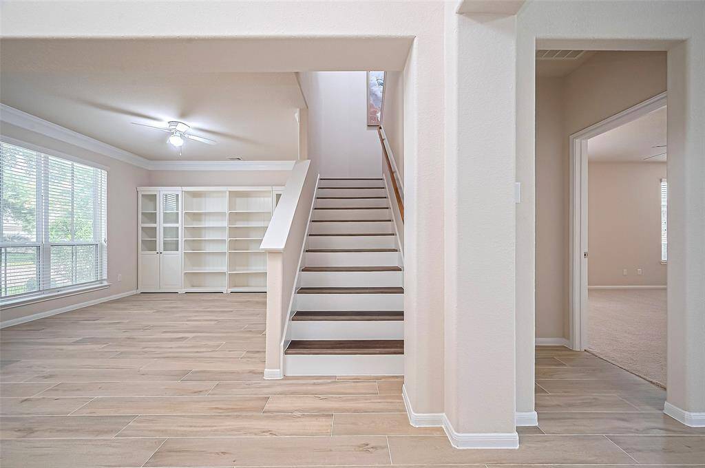 This home features a well-appointed study, luxury vinyl steps, and an inviting entrance to the master bedroom