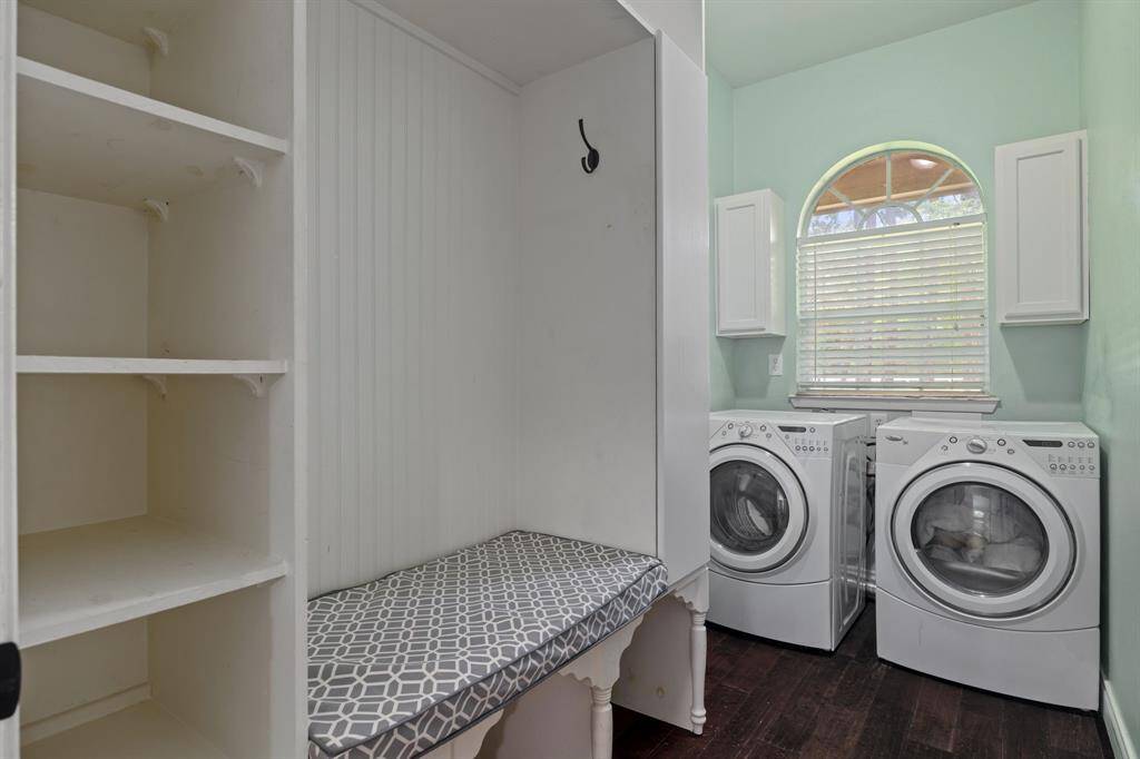 Laundry / Mud room with  built-ins featuring extra storage and convenient bench seat. Adjacent to garage entry - ideal for organization and everyday efficiency.