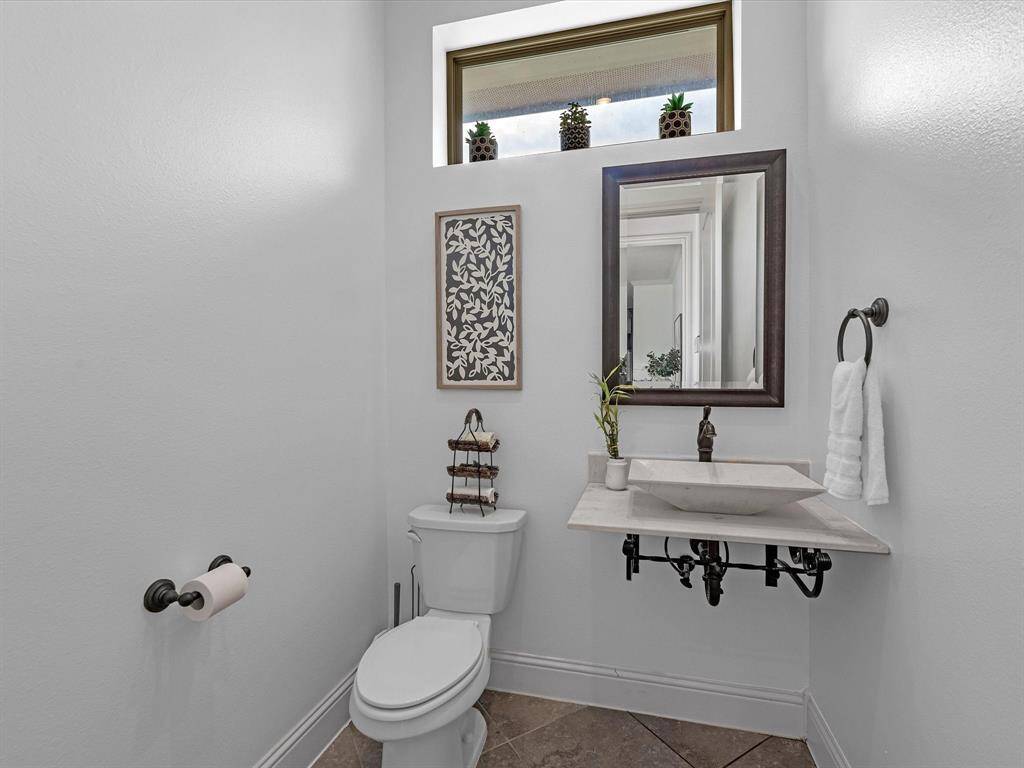 Half bath outside the kitchen and pool entry