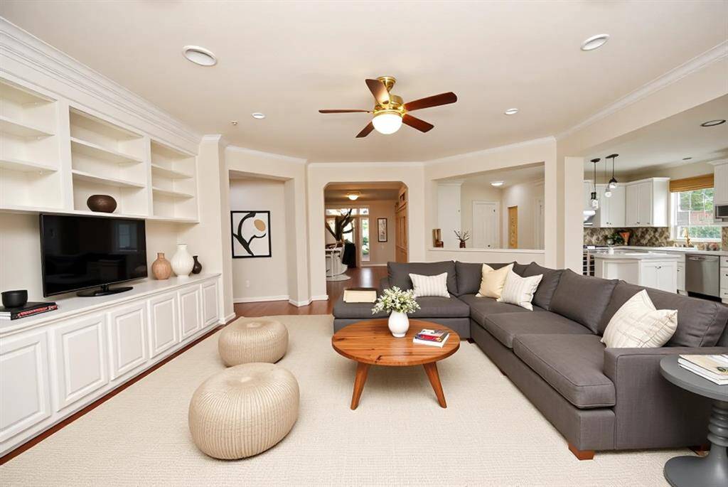 The heartbeat of the home with custom cabinets, fireplace, and opens to the kitchen.