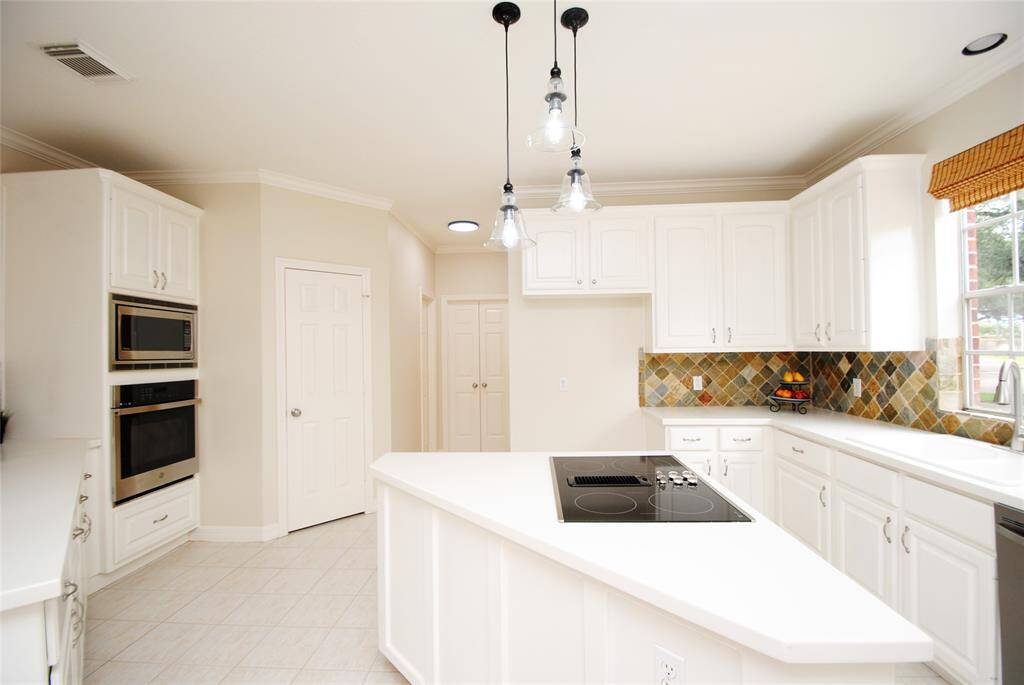 Kitchen offers stainless appliances and updated light fixtures.