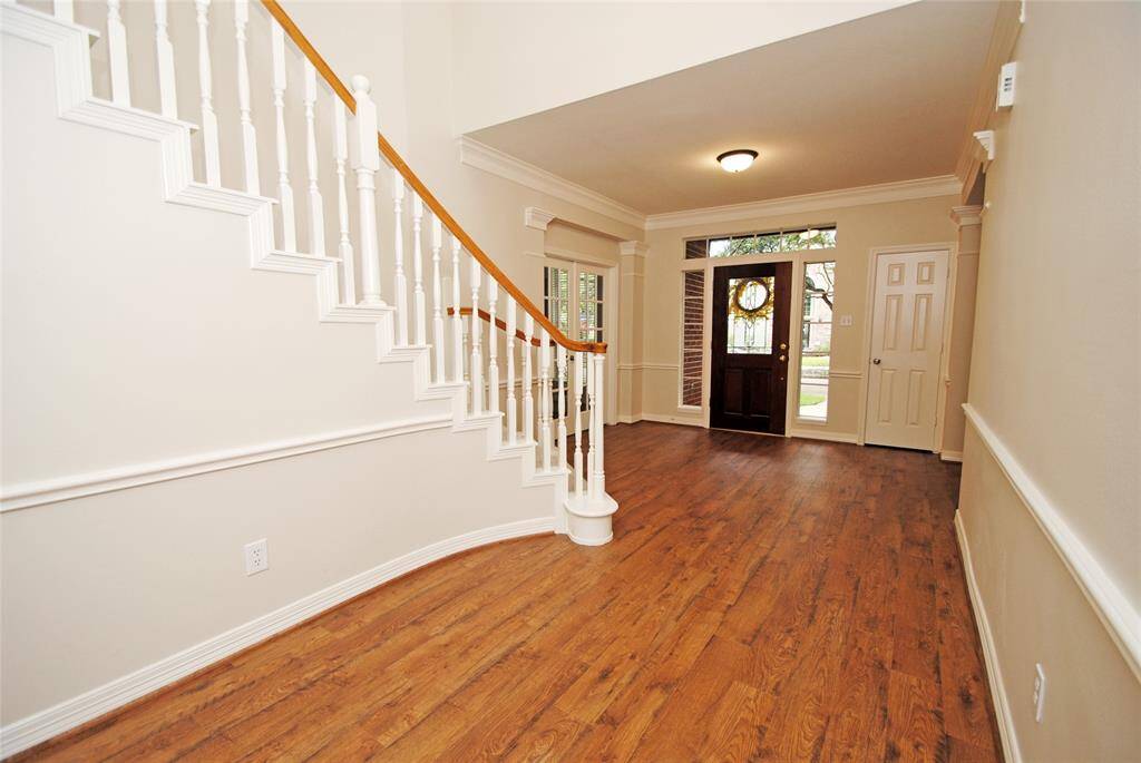 The entryway showcases the new vinyl plank flooring, and the whole house has been freshly painted!