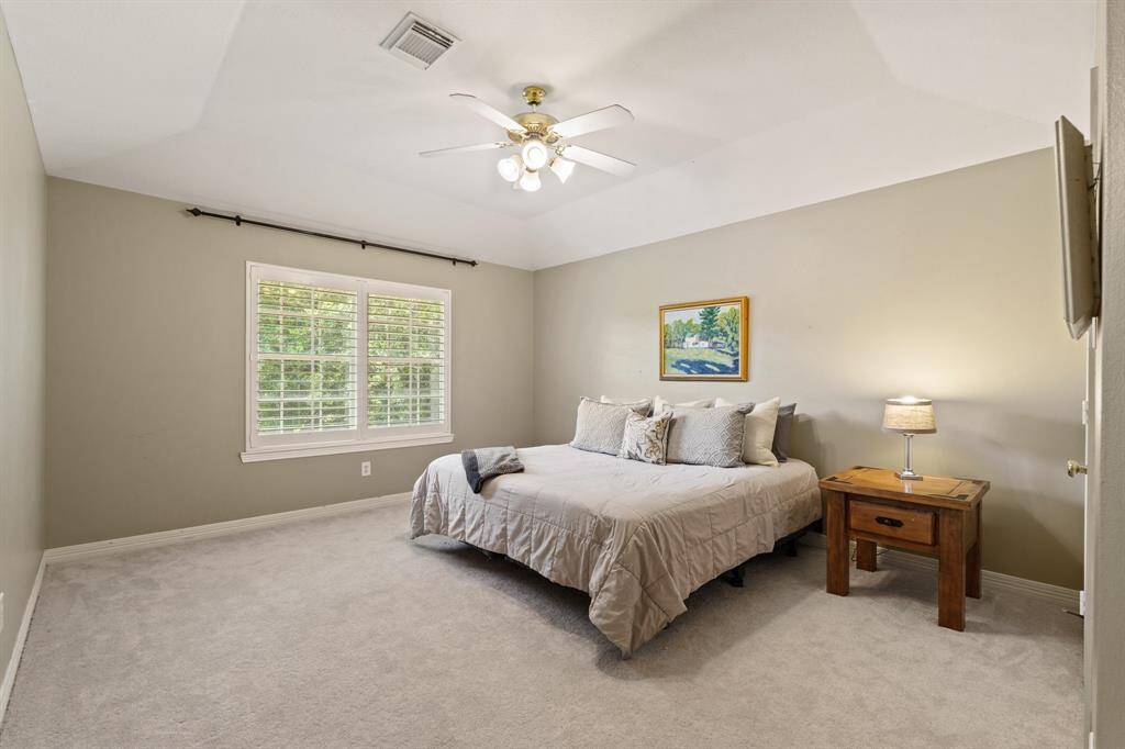 Neutral walls and a large window featuring plantation shutters and walk-in closet space. This room is large enough to utilize as a Media Room, Exercise Room or Flex Space.