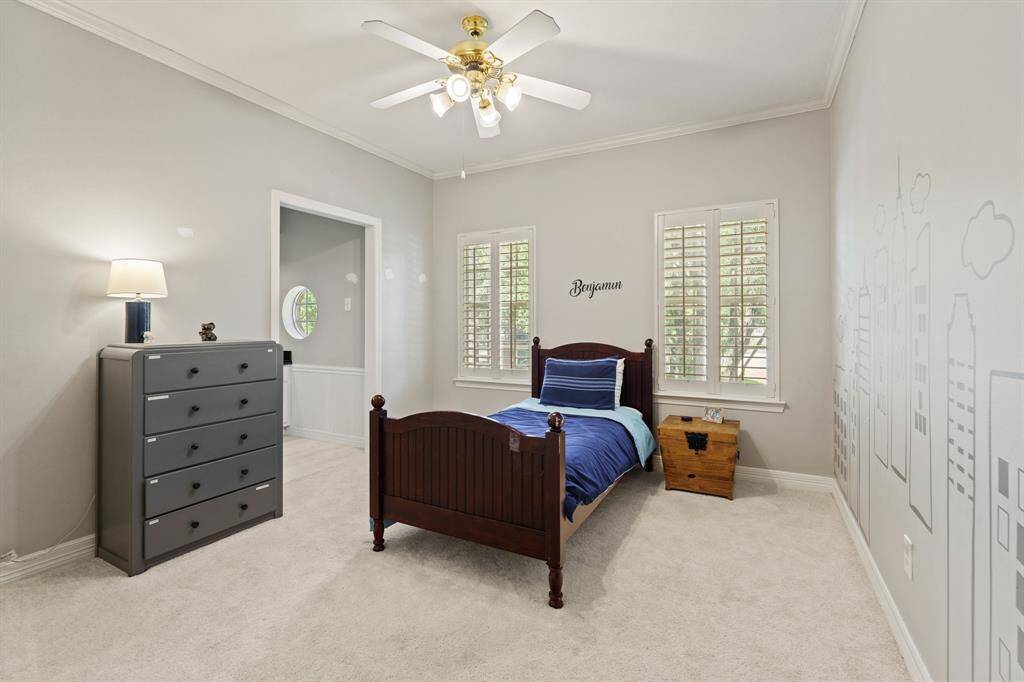 This nice size secondary bedroom features a decorative mural on the wall. Natural light streams in through plantation shutters. Good size closet space. Access to Jack and Jill bath area.