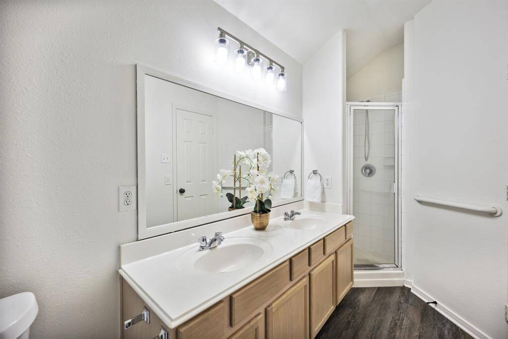 That fresh-tile feel! This updated en suite features dual sinks and a classic black-and-white shower for timeless style.