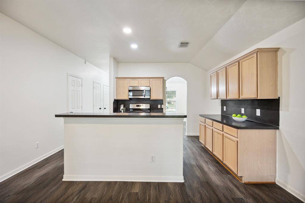 You’ll love the layout—tons of cabinets, a generous island, and space that keeps things moving.