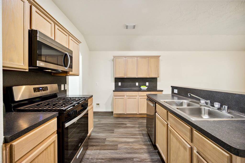 Stainless steel appliances, gas cooking, and a spot for everything—because a kitchen should be as functional as it is beautiful.