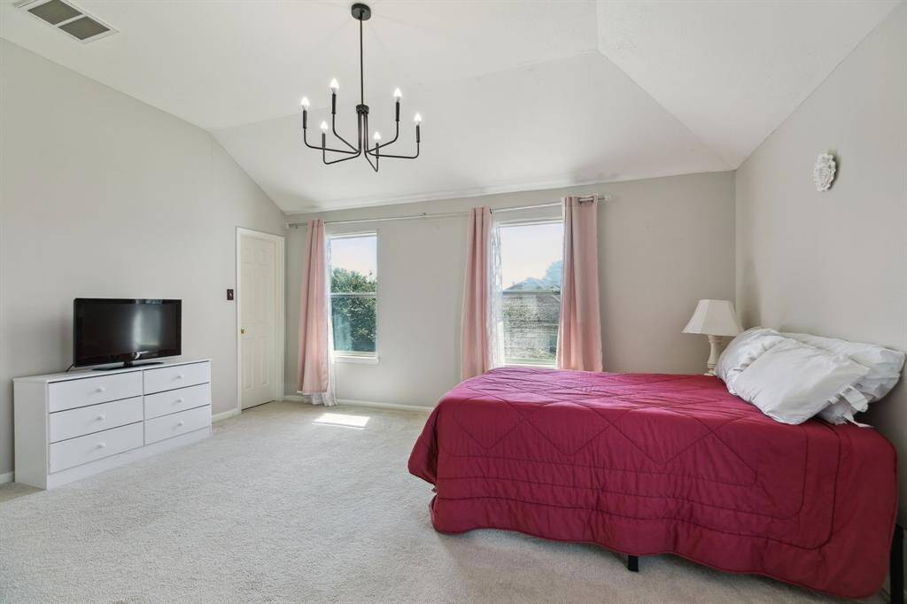 This primary suite offers the convenience of two spacious closets.