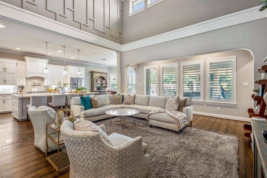 A wall of windows offer stunning views of the backyard oasis, the windows all have plantation shutters.