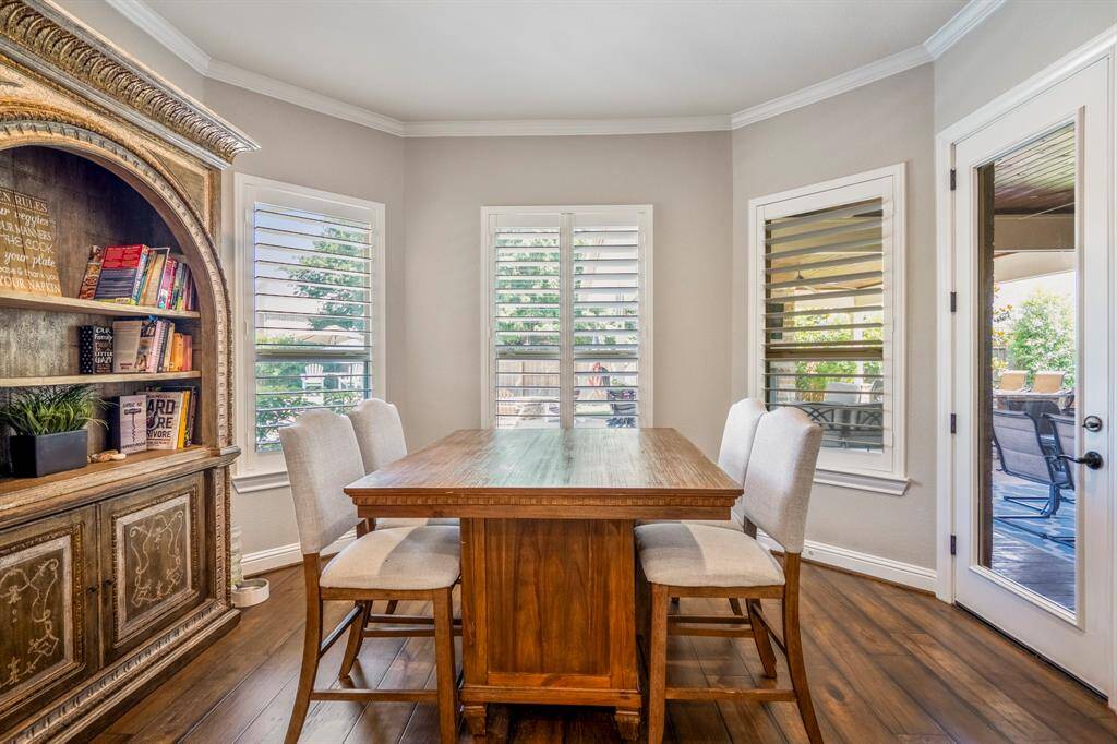 Enjoy the breakfast room that offers 3 large windows (all with plantation shutters) and a glass door that peeks out to an alluring backyard.