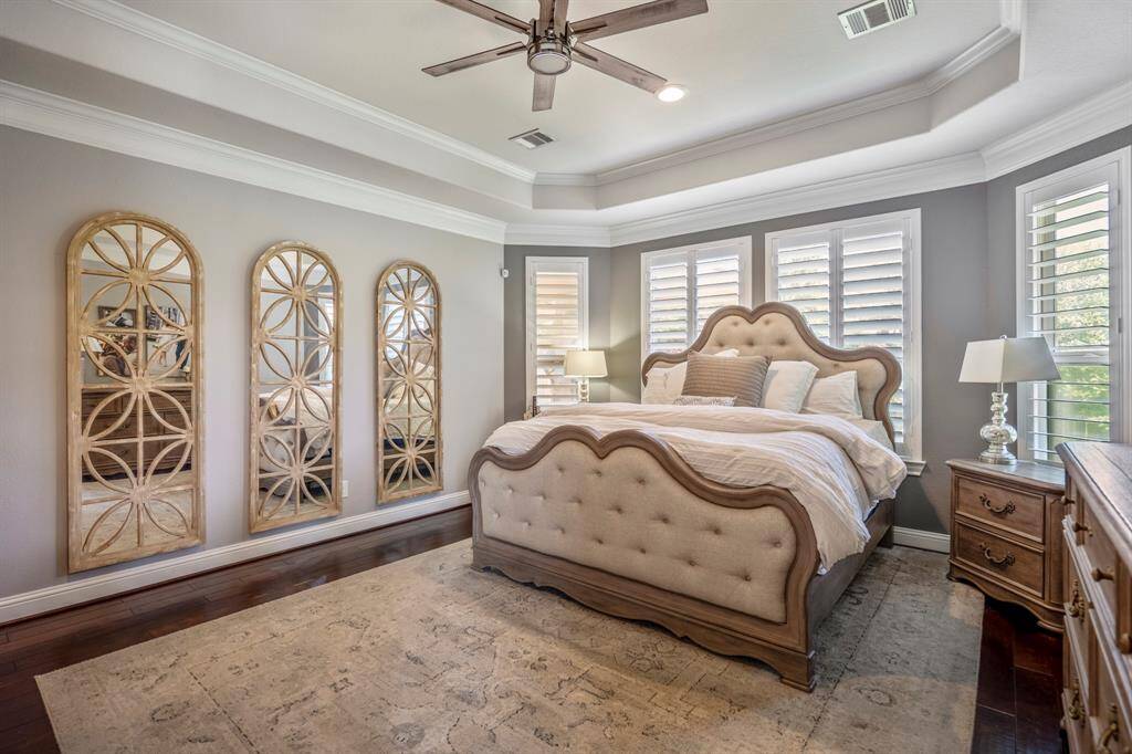 The primary bedroom suite offers a soothing color palette offering a delightful retreat from the busy gathering spaces of the living area.