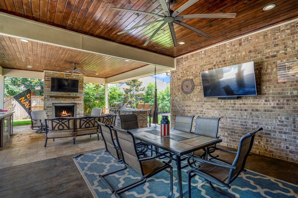 Step outdoors to an outdoor living area that has multiple areas to relax and entertain in a rustic elevated outdoor patio.